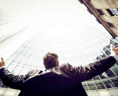 low-angle photography of man in the middle of buidligns