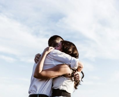 man and woman hugging each other photography