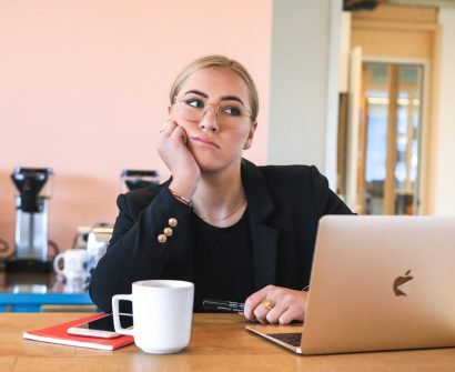 woman in black long sleeve shirt using macbook